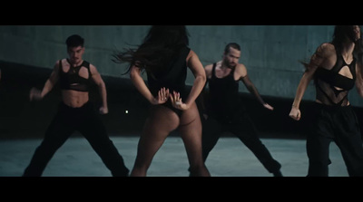 a group of dancers are dancing in a dark room