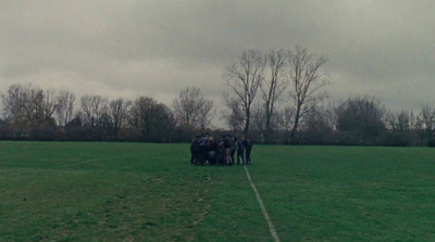 a group of people standing on top of a lush green field