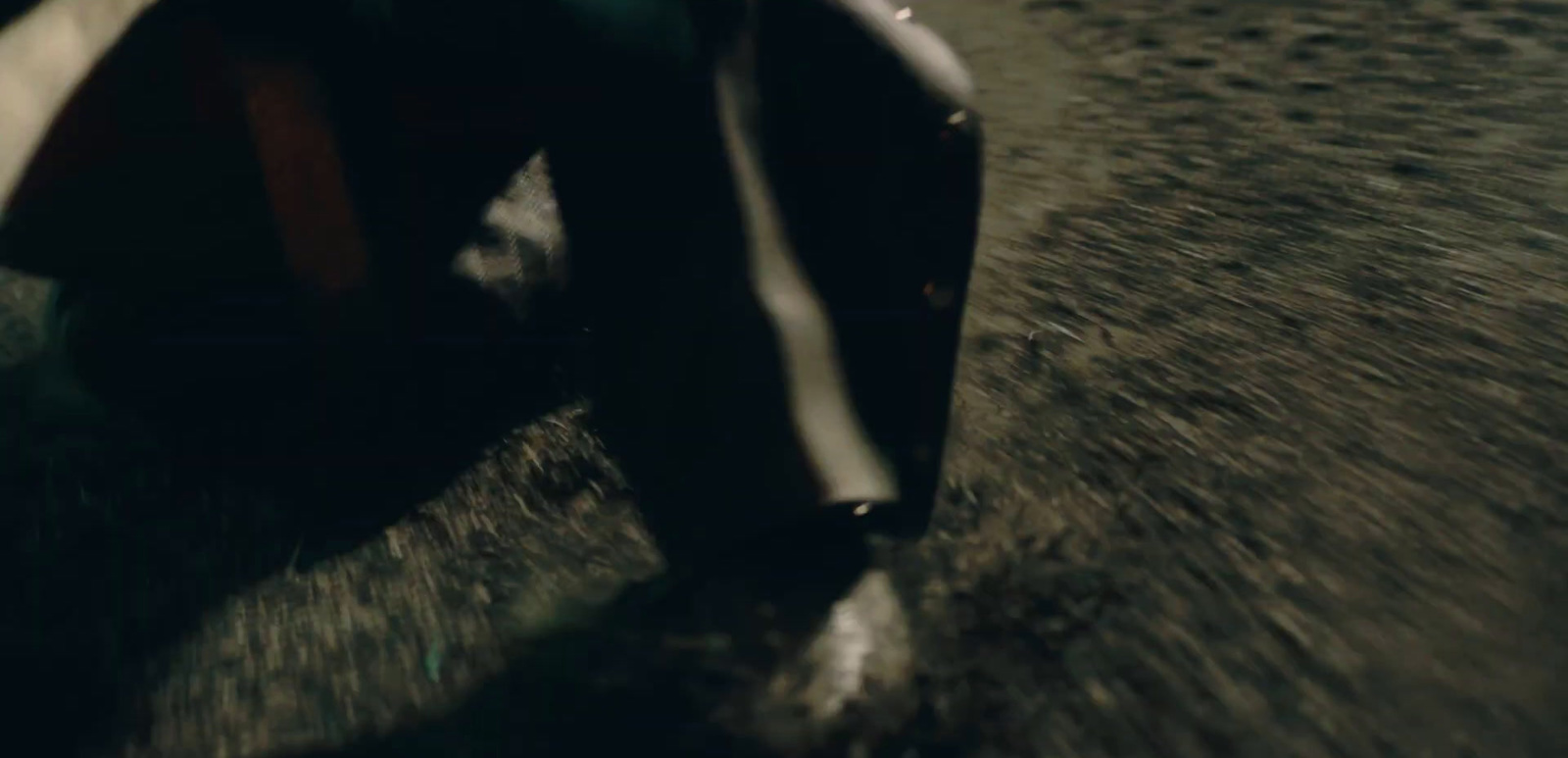 a man riding a skateboard down a street at night