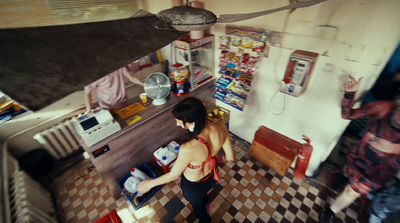 a woman standing in a kitchen next to a stove top oven