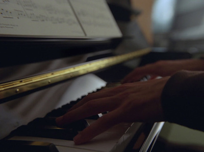 a close up of a person playing a piano