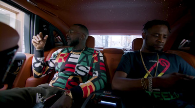 two men sitting in the back of a car