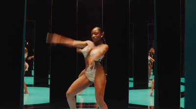 a woman in a white bodysuit dancing in front of mirrors