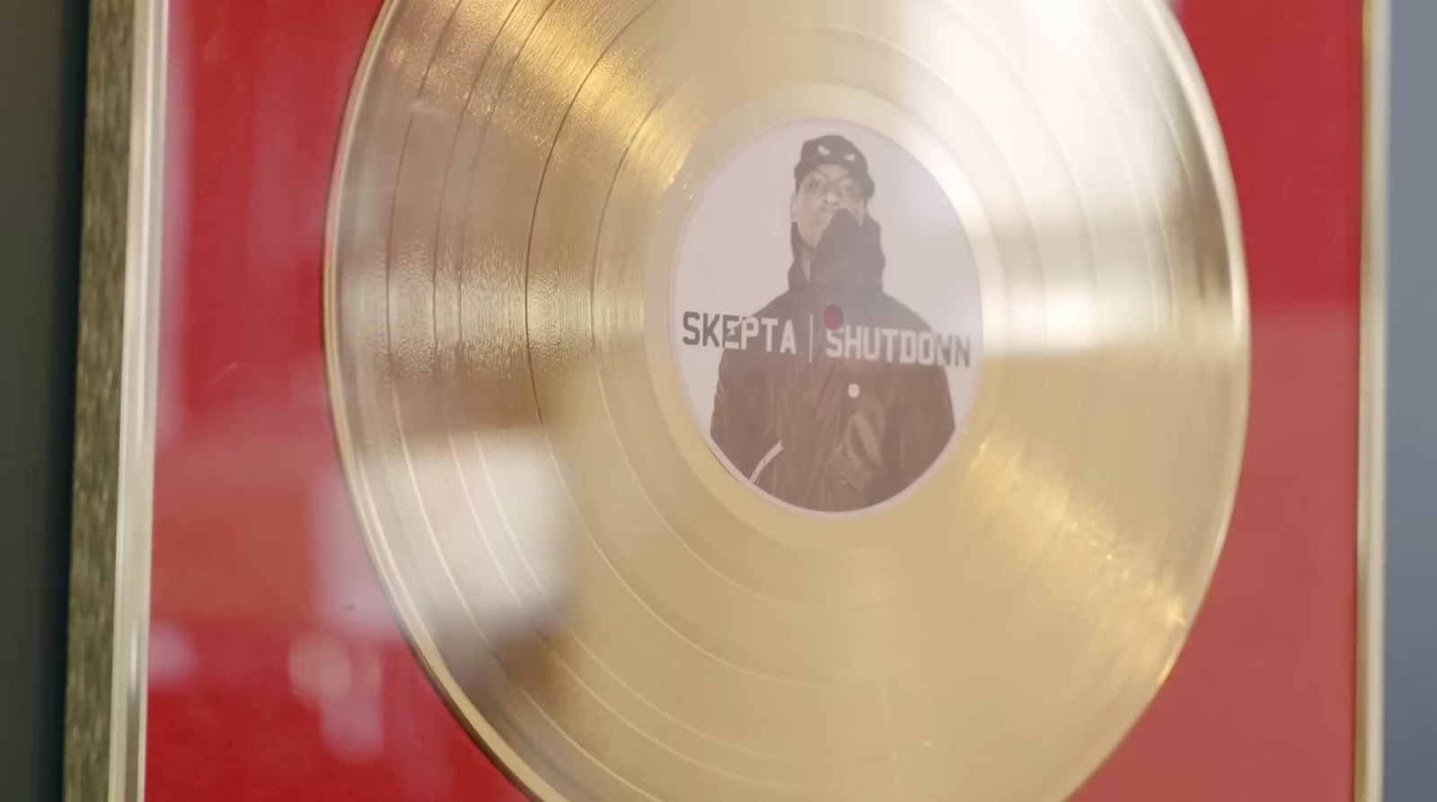 a gold record with a picture of a man on it