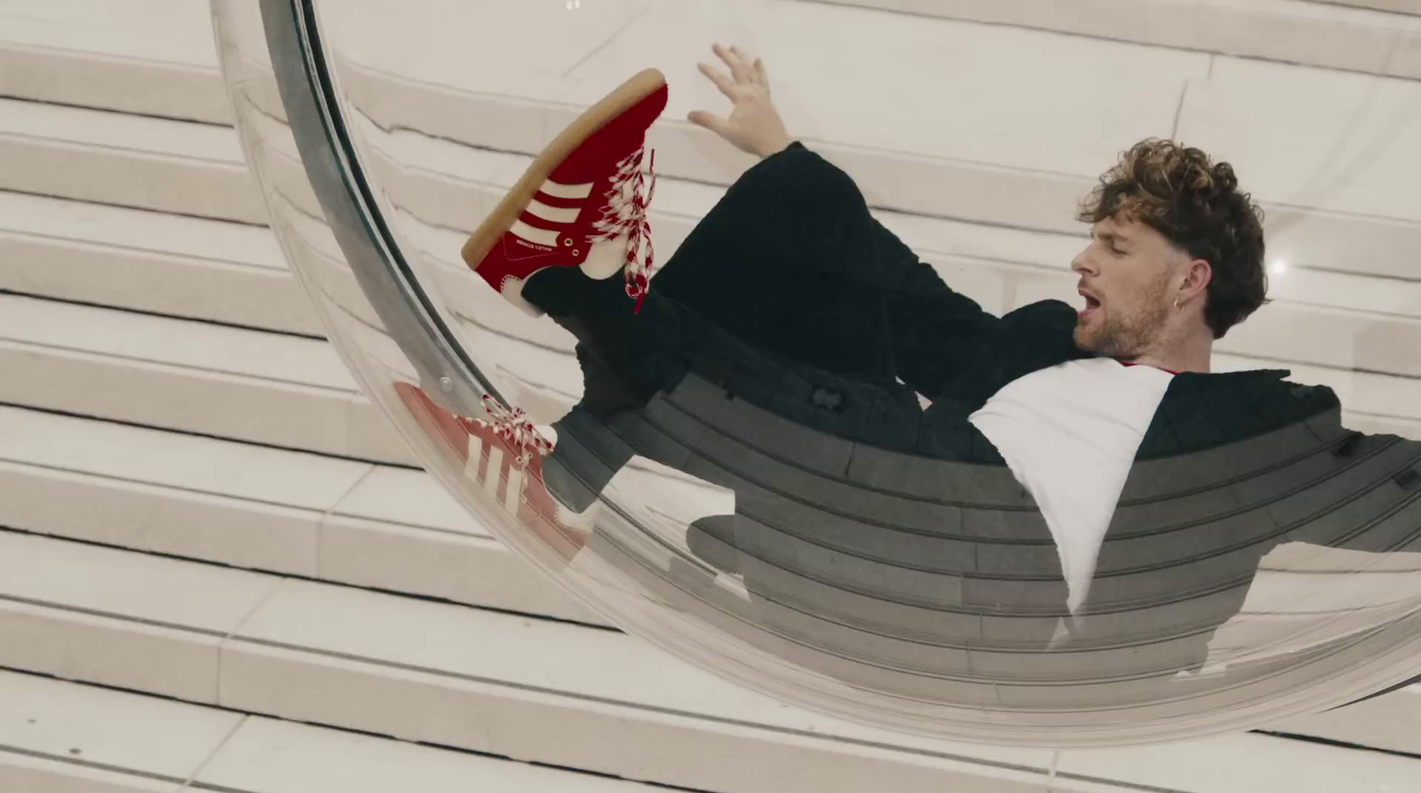 a man laying on a hammock with his feet in the air