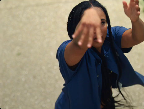 a woman holding her hand up in the air