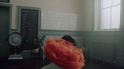 a person with a red wig in a room