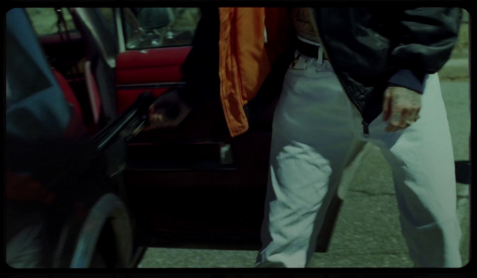 a man standing next to a car with a tie on