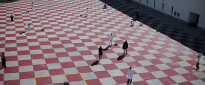 a group of people standing on top of a checkered floor