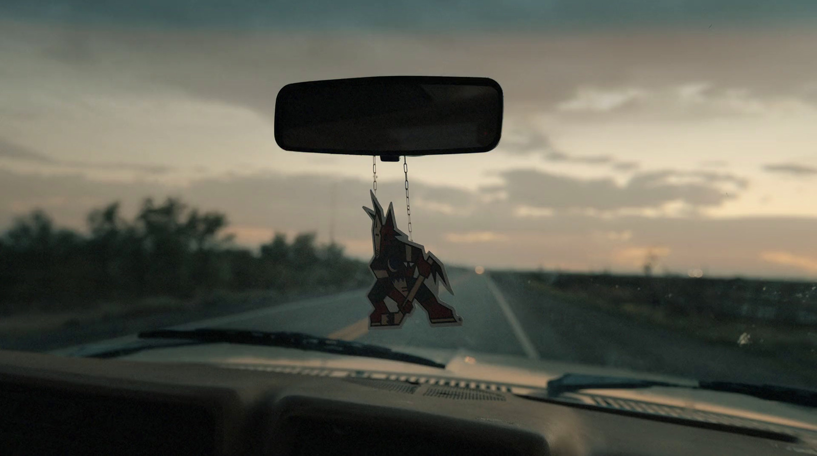 a car dashboard with a hanging origami decoration