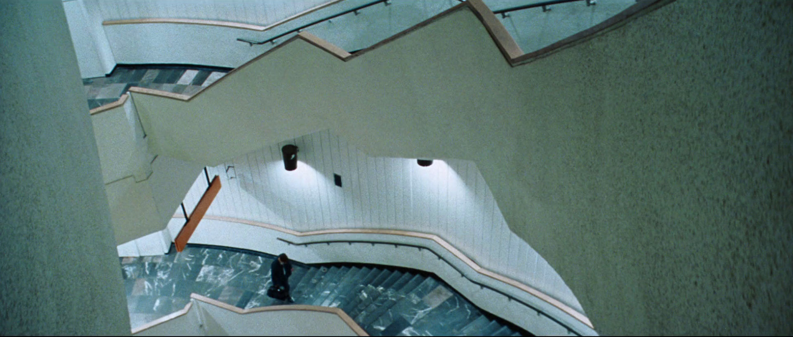 a view from the top of an escalator of a building