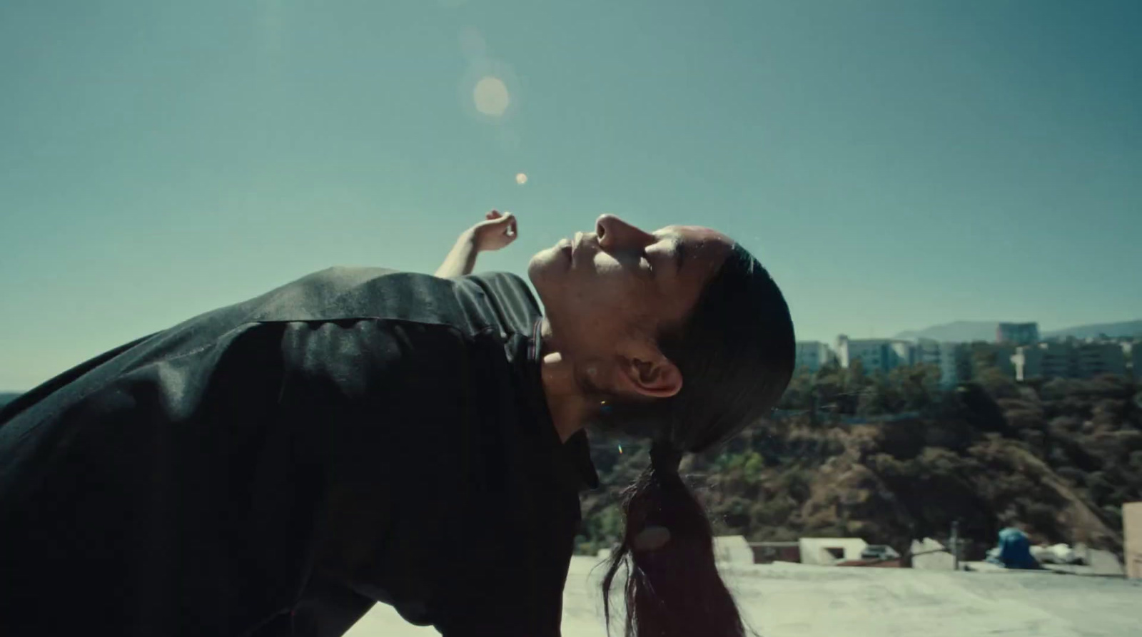 a woman blowing a cigarette on a sunny day