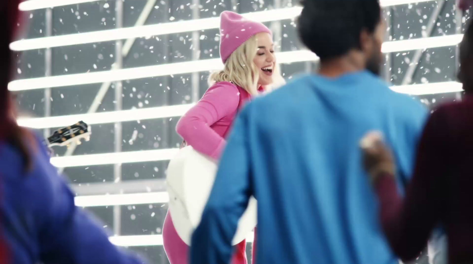 a woman in a pink outfit is dancing in the snow