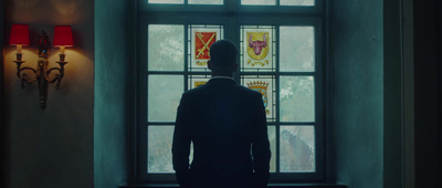 a man standing in front of a stained glass window