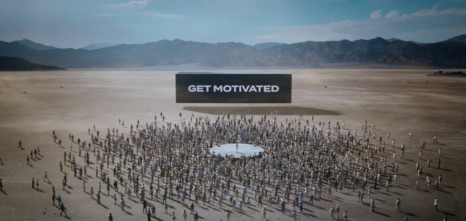 a group of people standing in the middle of a desert