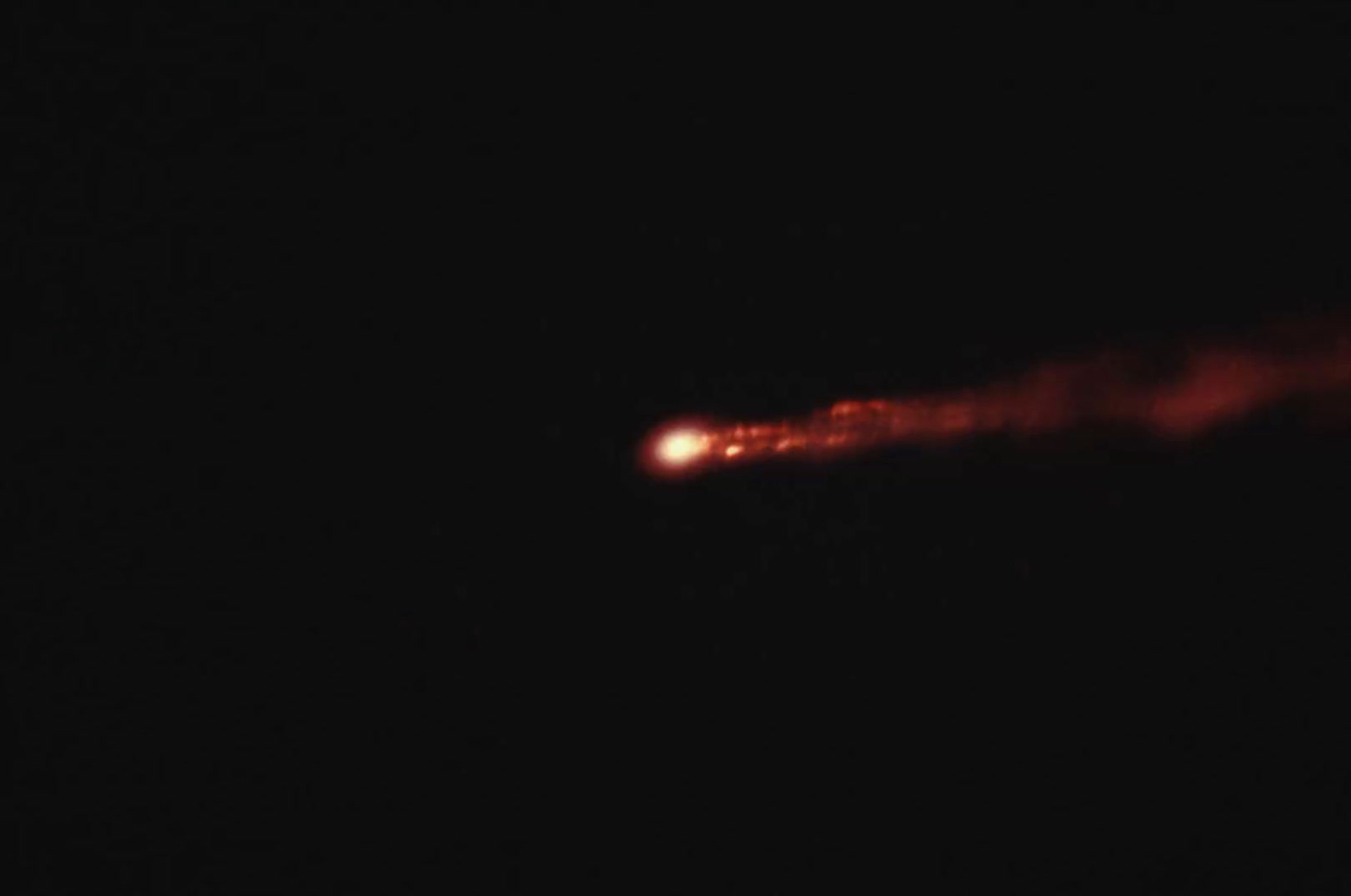 a blurry image of a red object in the dark