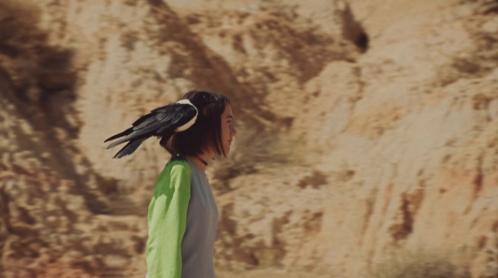 a woman with a bird on her head