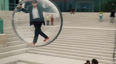 a man is walking in a glass ball