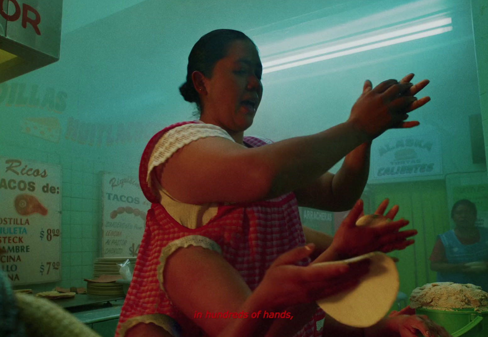 a woman in a red and white dress holding a pizza