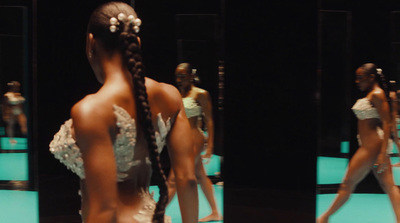 a woman in a white dress standing in front of a mirror