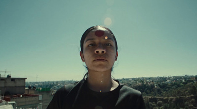 a woman standing in front of a blue sky