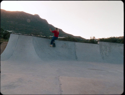 a man riding a skateboard up the side of a ramp