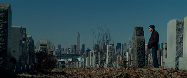 a man standing on top of a cemetery