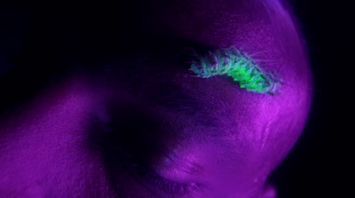 a close up of a person's eye with a green eyeliner