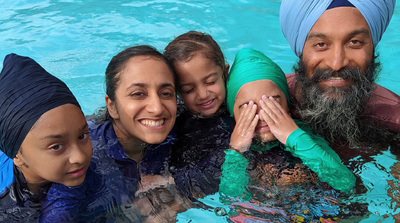 a group of people standing in a swimming pool