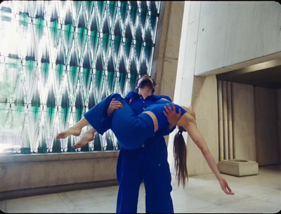 a man and a woman doing a handstand in front of a building