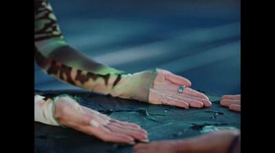 a woman's hands with a ring on top of a cake