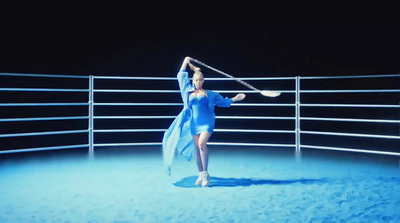 a woman in a blue dress is dancing