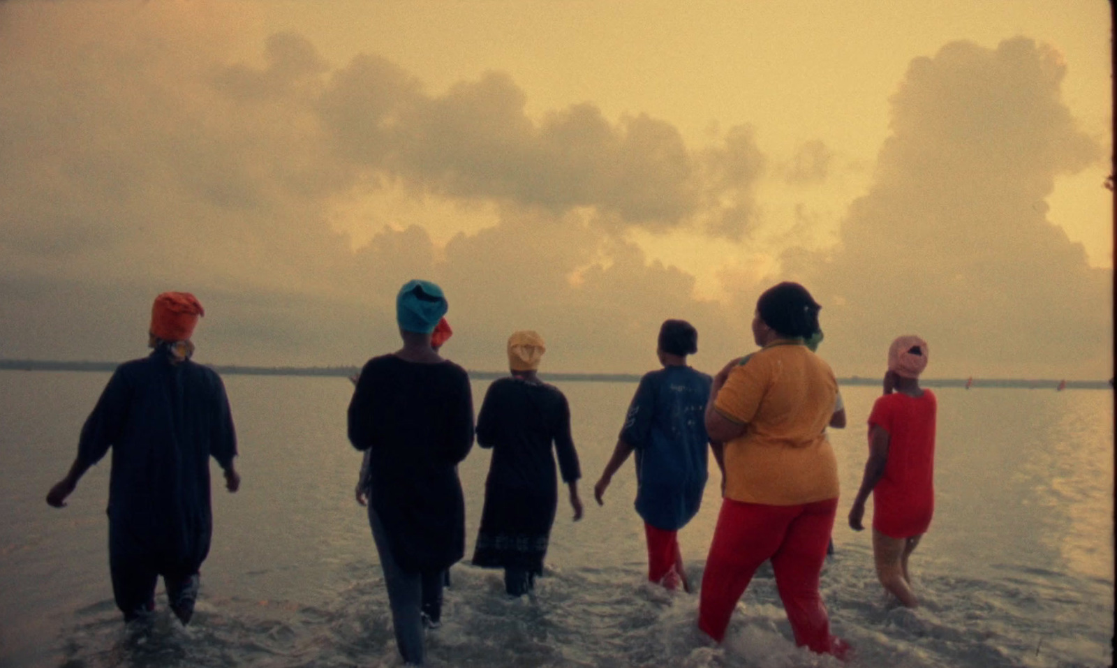 a group of people standing in the water