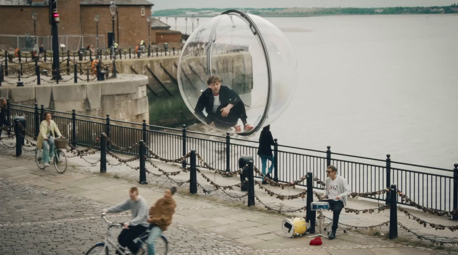 a group of people riding bikes next to a body of water