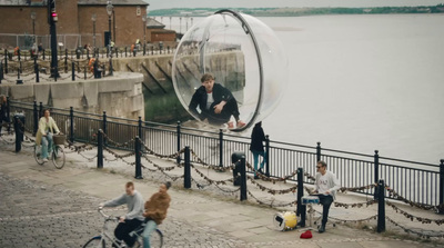 a group of people riding bikes next to a body of water