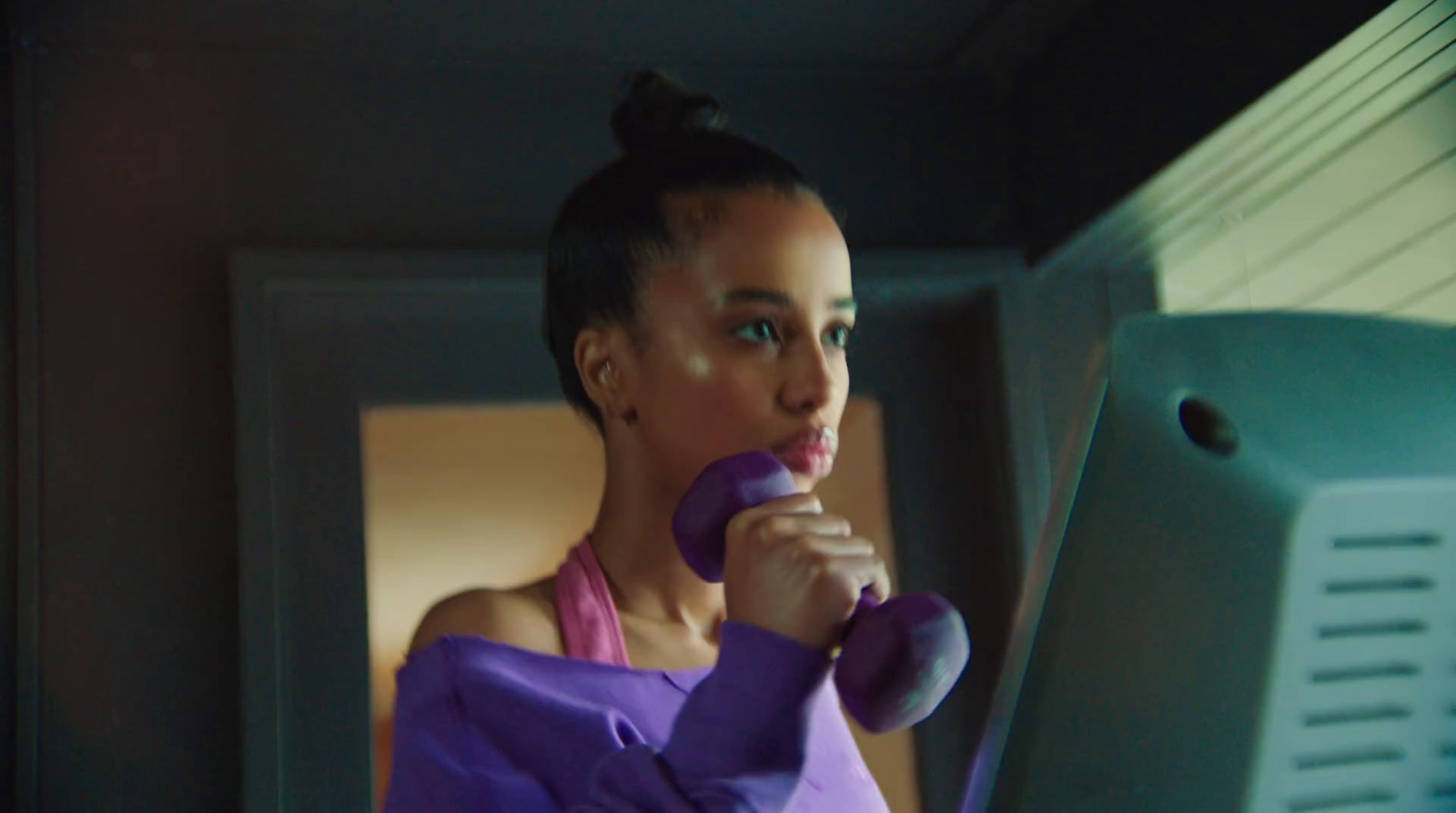 a woman in a purple dress holding a purple object