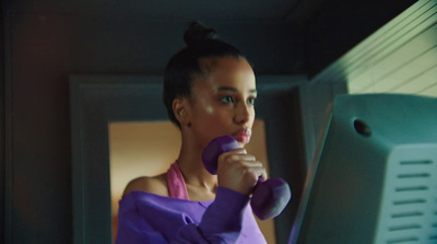 a woman in a purple dress holding a purple object