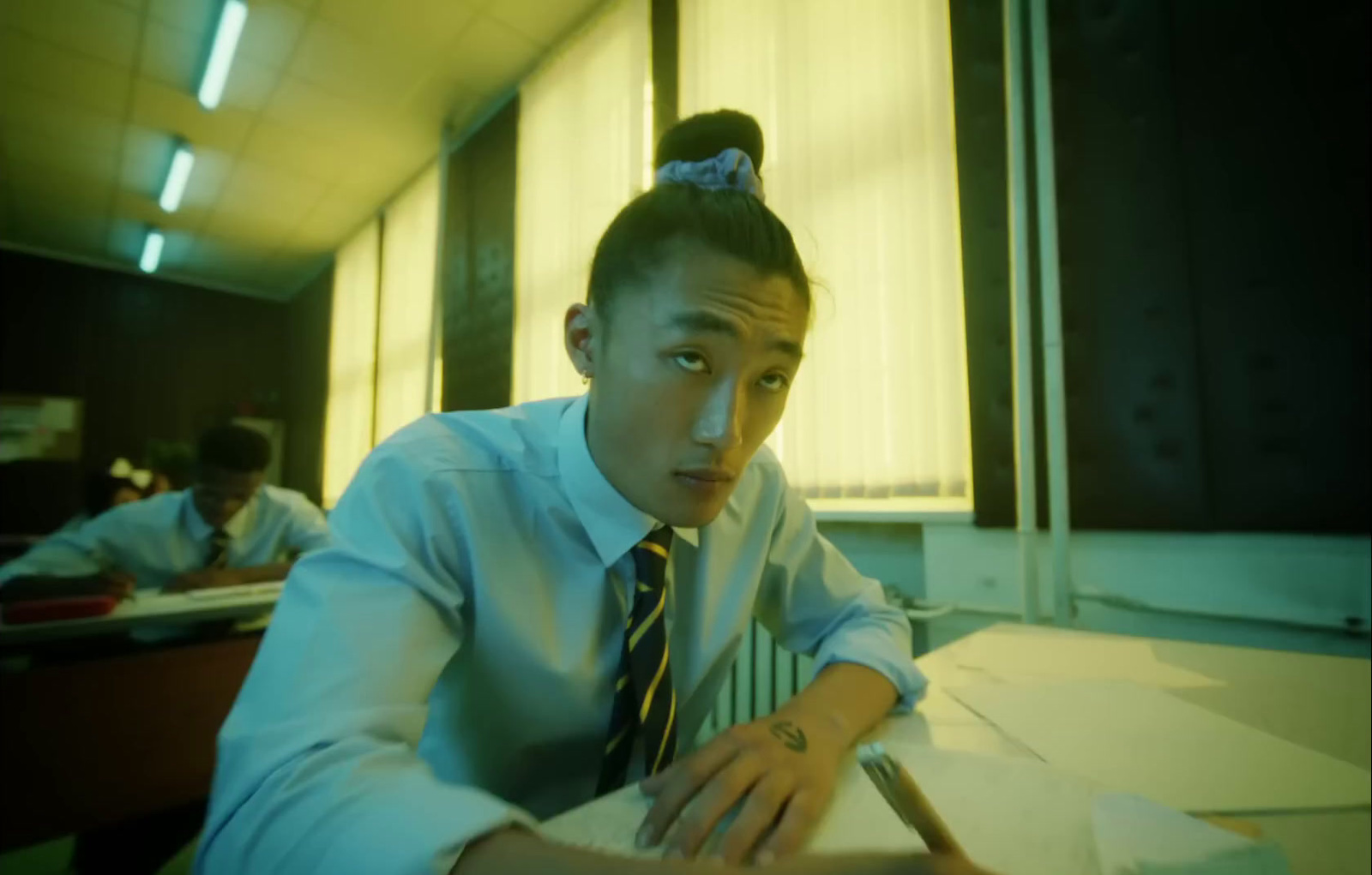 a man sitting at a desk with a pen in his hand