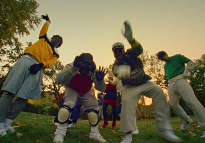 a group of people standing on top of a lush green field