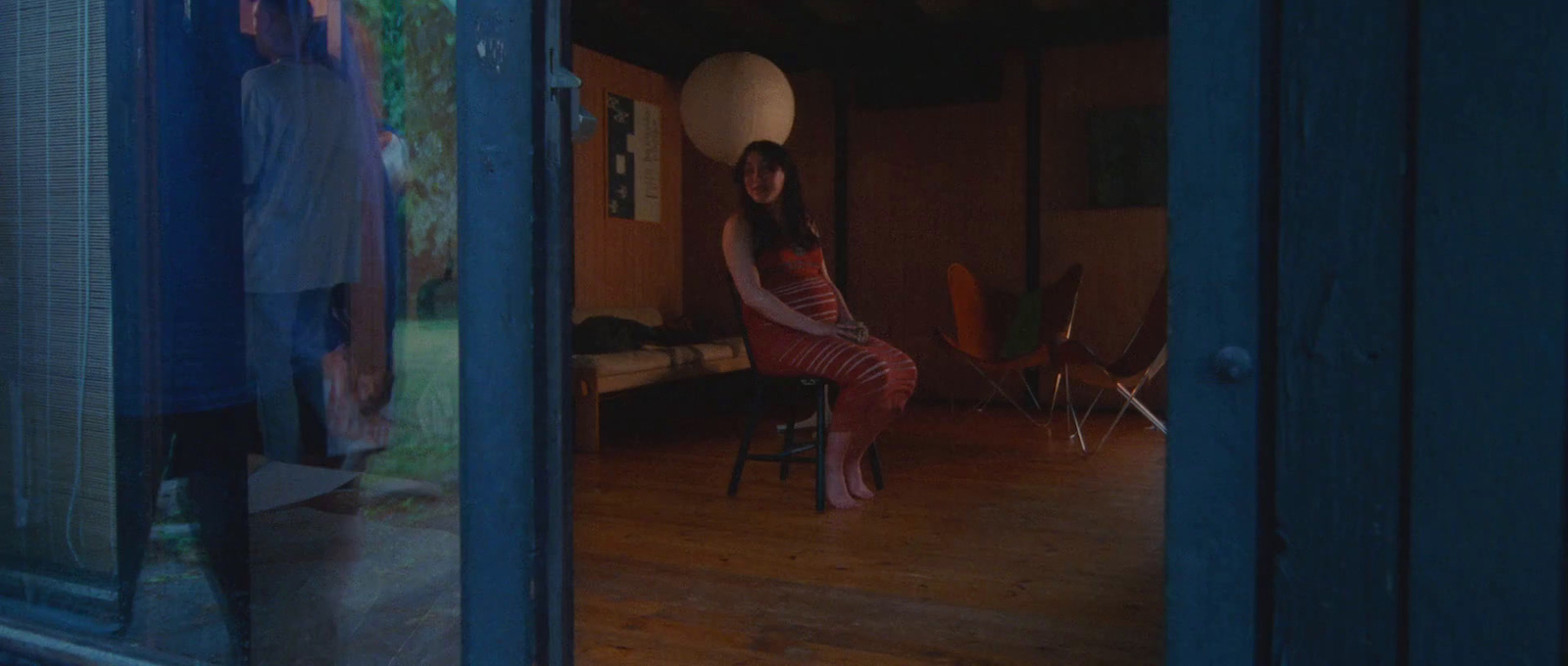 a woman sitting on a chair in a room