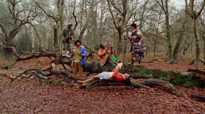 a group of people standing around a fallen tree