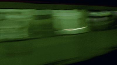 a blurry photo of a green train