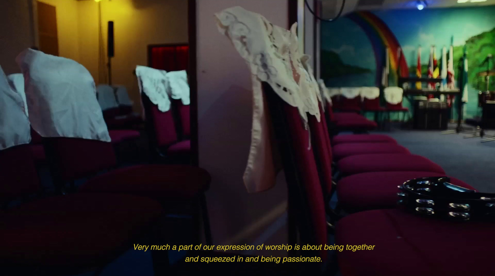 a row of red chairs with white shirts on them