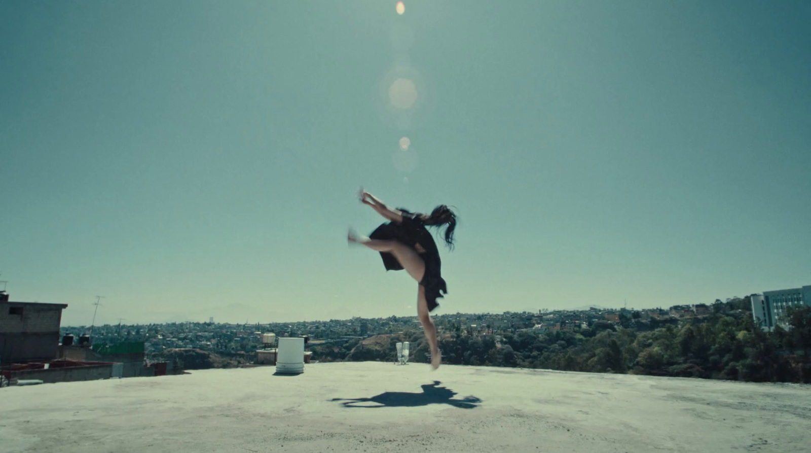 a woman is doing a trick on a skateboard