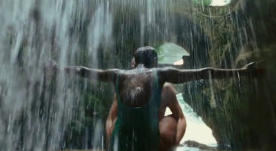 a man standing in front of a waterfall