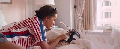 a woman laying in bed reading a book