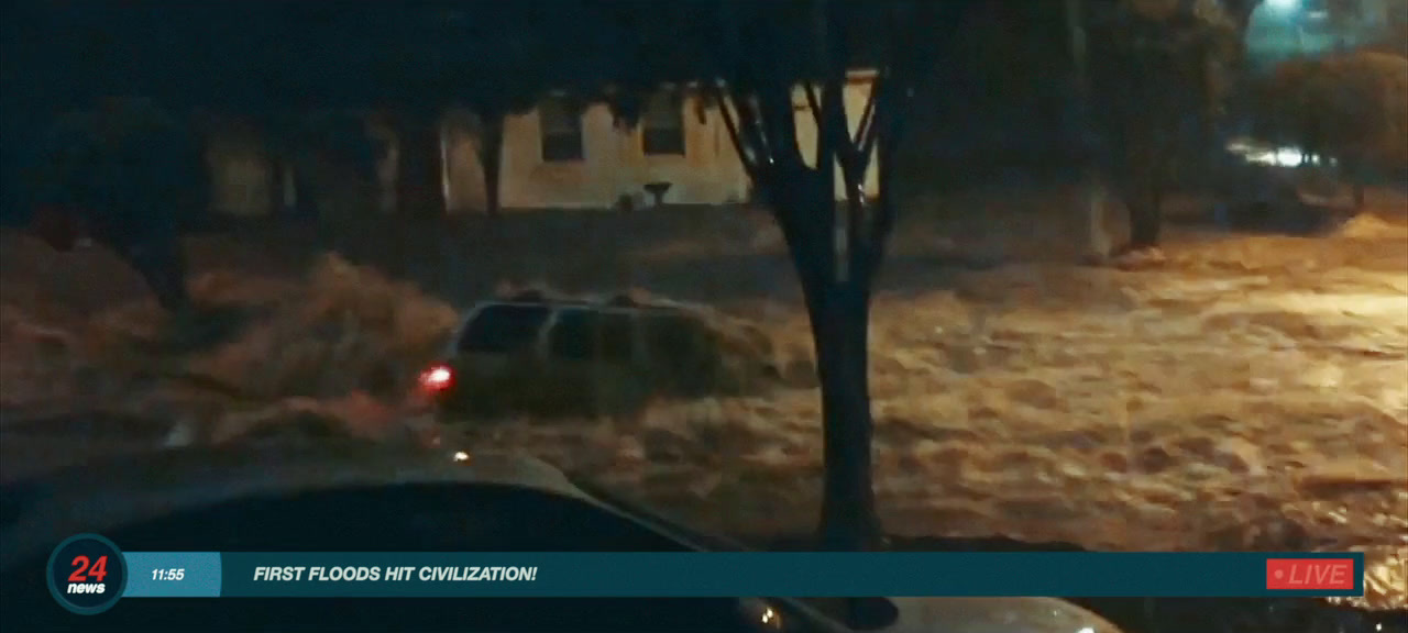 a car driving through a flooded street at night