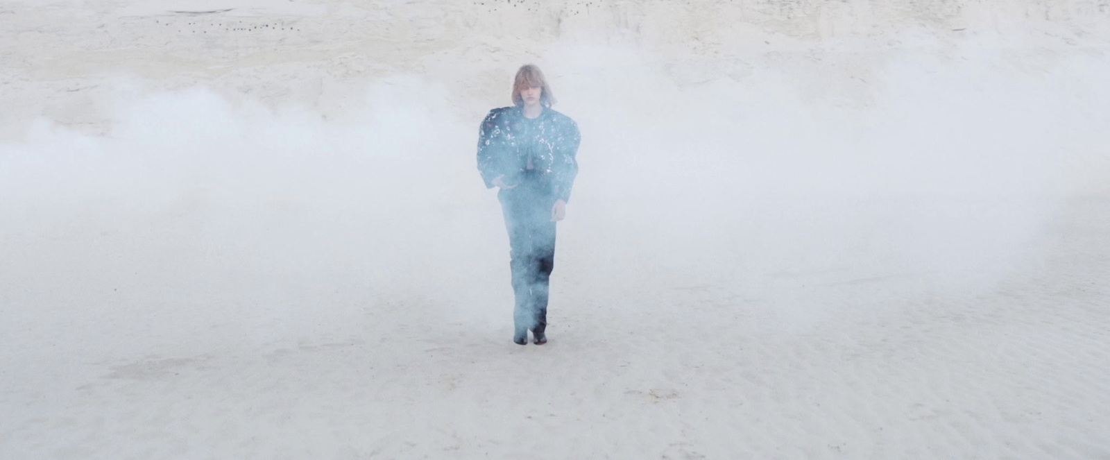 a woman standing in the middle of a dust storm