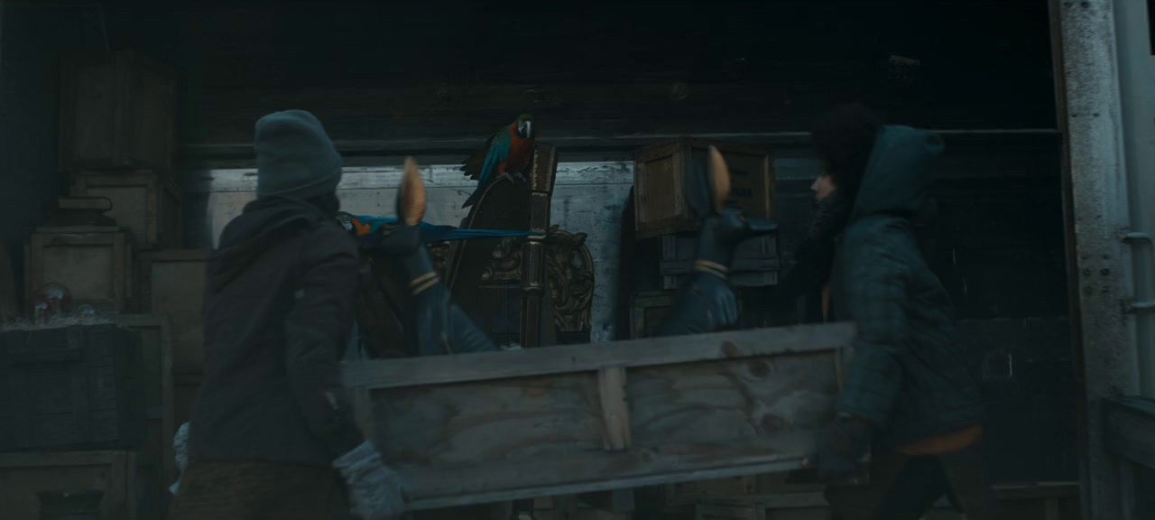 a group of people standing around a wooden crate