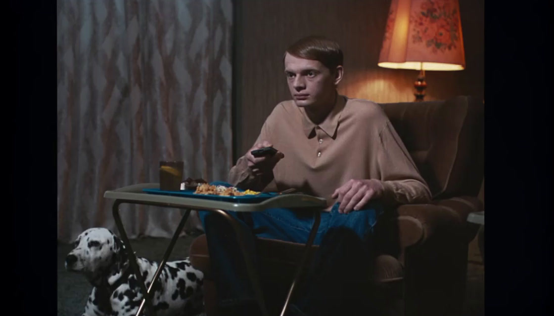 a man sitting in a chair with a tray of food